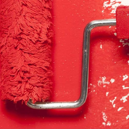 Paint roller and tray with red paint
