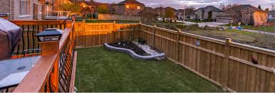 View of backyard with porch, lawn, fence, and other houses in neighborhood in background