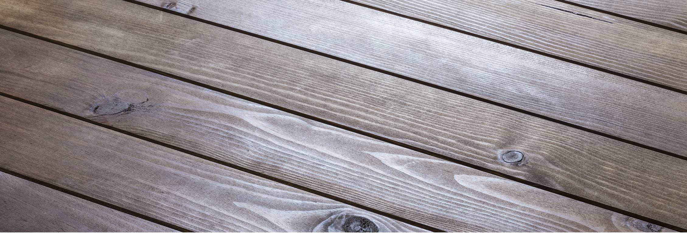 Grayish-brown wooden panels with light shining off it