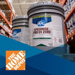 Angled zoomed picture with two gray and white PPG paint buckets with orange shelves in background, blue hued shapes at bottom and "The Home Depot" logo at front