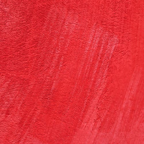 Red wall with visible paint strokes