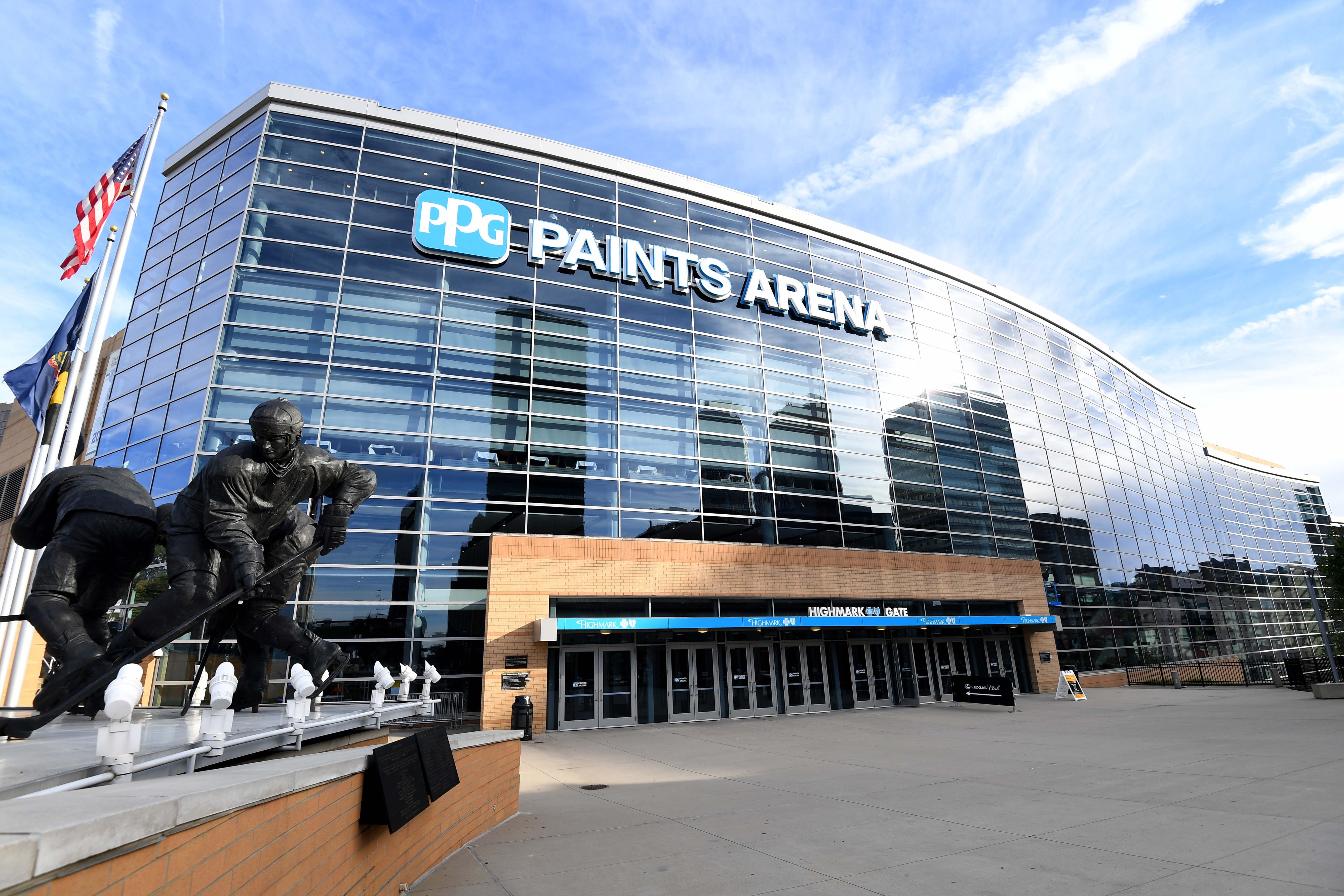 PPG Paints Arena stadium with large hockey player statue on left
