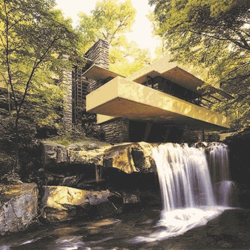 Fallingwater house with trees in background and rocks and waterfall in foreground