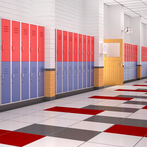Large hallway with gray, red, and white floor tiles with red and blue lockers and white and yellow pillars with white tile ceiling and yellow door in background
